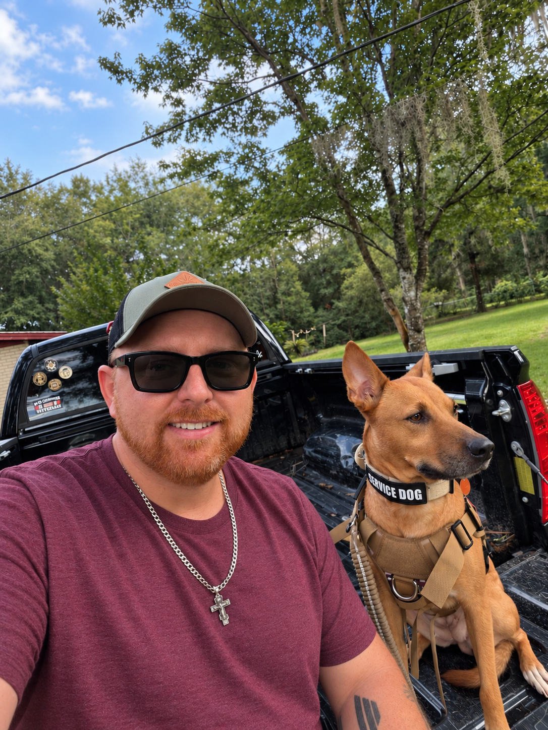 James and Liberty, his service dog, together at the back of the Tundra.